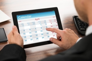 40751886 - close-up of a businessman using calendar on digital tablet in office